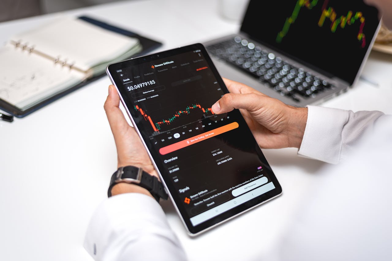 why-choose-us Professional analyzing cryptocurrency market data on a digital tablet with financial graphs.